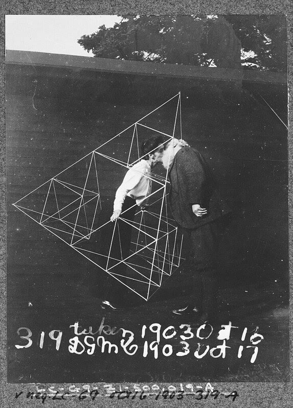 Alexander Graham Bell and Mabel Bell standing within a tetrahedral kite frame